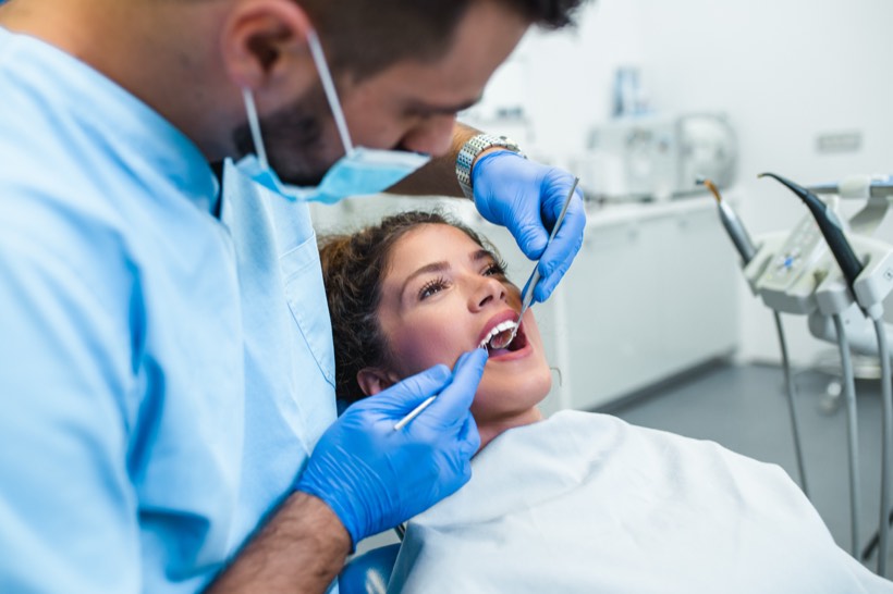 Dentist treating a patient in the chair