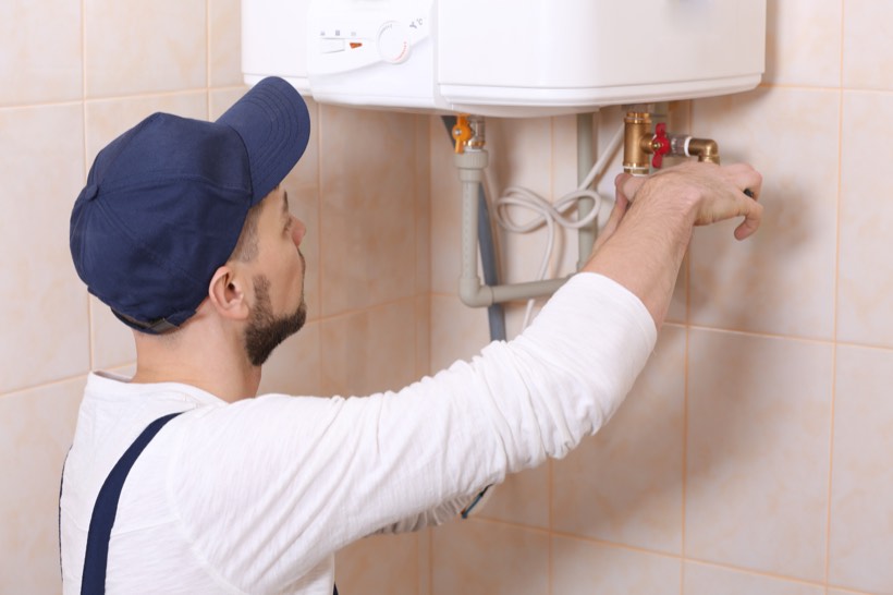 Plumber installing a water heater