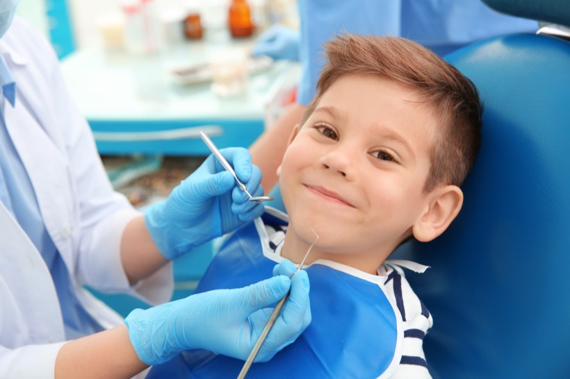 Dentist gently examining a child's teeth